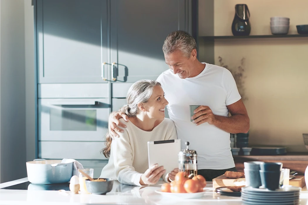 Man and woman in kitchen smiling at each other