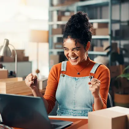 Woman in a workshop looking at a laptop