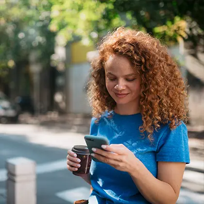 Woman looking down at her mobile phone and smiling
