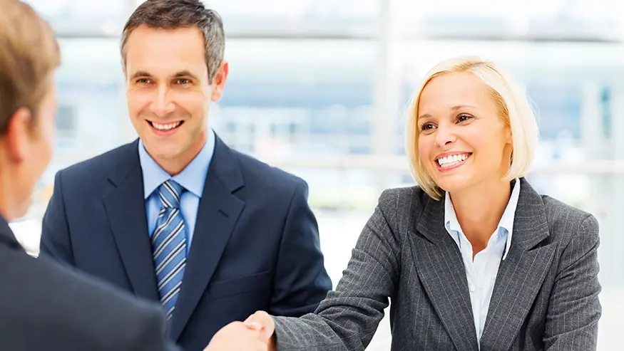 Professional couple meeting with a trustee to discuss institutional trustee needs for a benefit plan 