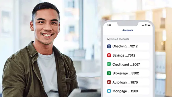 Person at laptop with overlay showing linked bank accounts in the mobile app