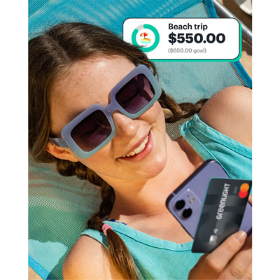 Teen with Greenlight debit card tracking a goal in the app