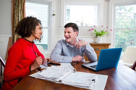 Couple using a laptop to order checks online