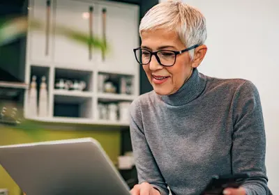 Customer viewing overdraft reversal on a laptop
