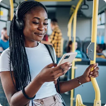 Young adult viewing her student checking account on a smartphone during a commute