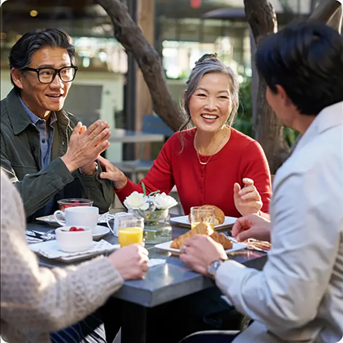 Group of adults dining at an outdoor restaurant