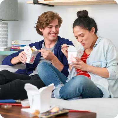 Couple enjoying takeout thanks to smart money management