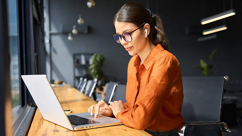 Woman using laptop with airpods
