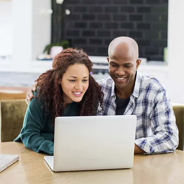Couple looking at a laptop together