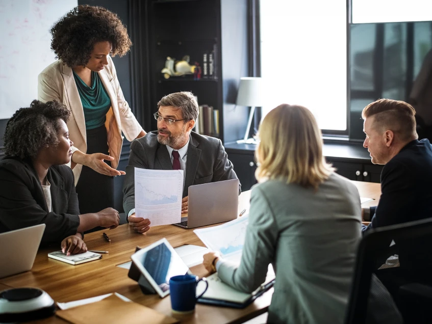 Financial advisor discussing specialty asset management with clients in office