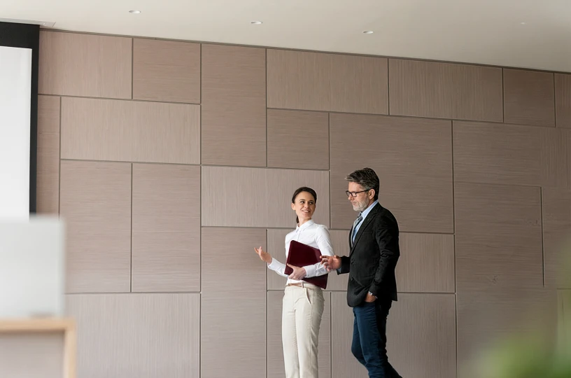 two leadership prfessionals walking in meeting room