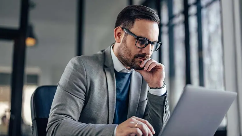 business owner reviewing business transition options on computer