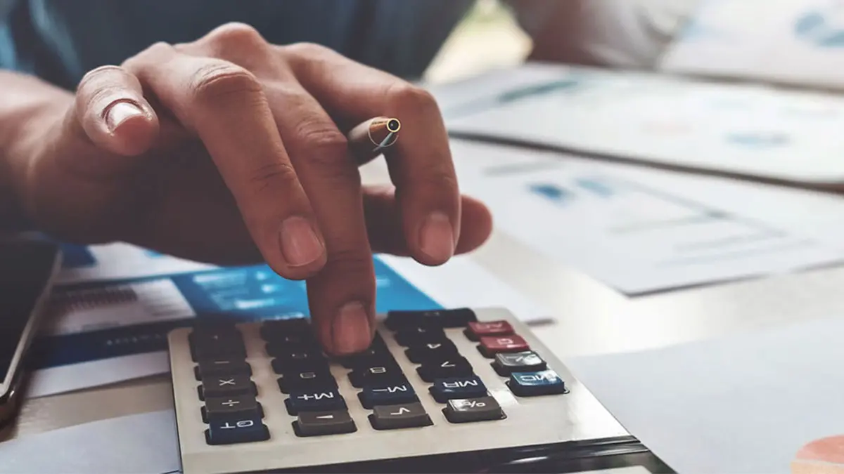 Close-up hand using calculator