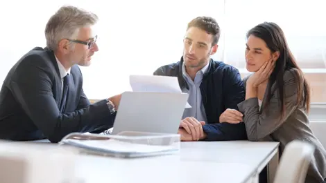 young couple talking to account manger about portfolio