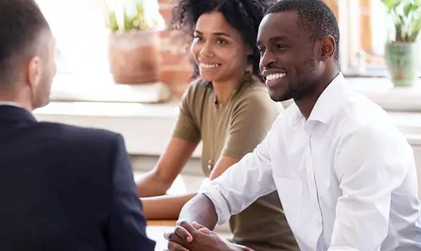 Young couple talking with account manager