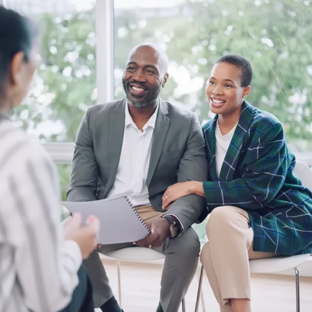 Middle-aged couple meeting virtually with her financial advisor