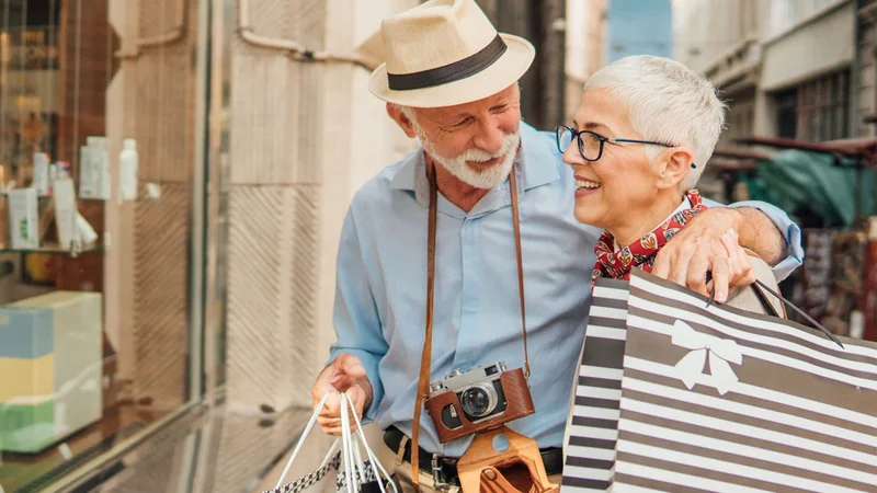 Couple looking at a shop window while considering purchases.