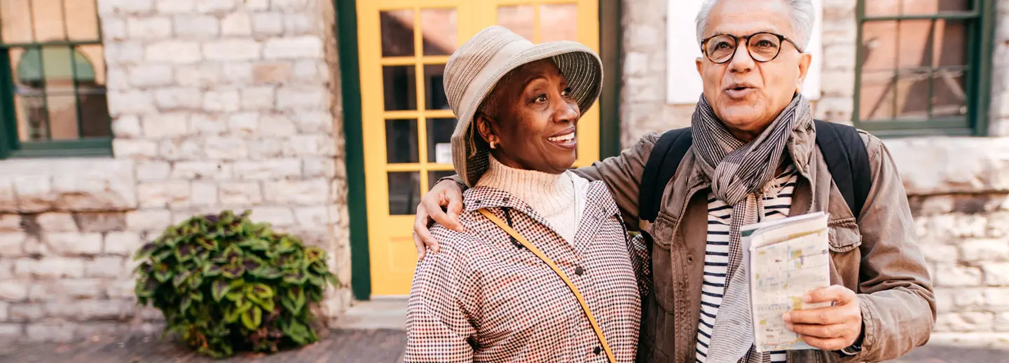 husband and wife holding a map and exploring a new city
