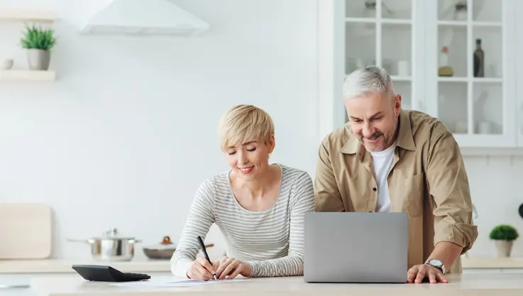 couple discuss taxes in their kitchen