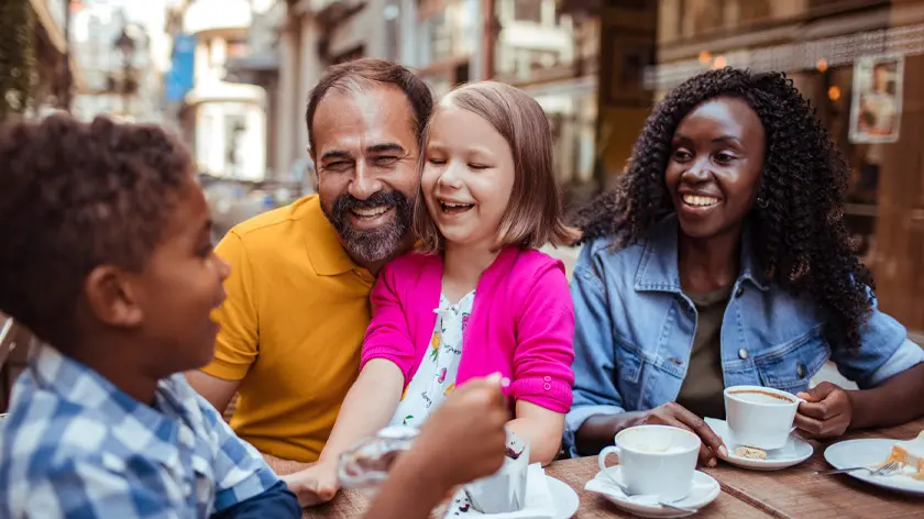 father, mother, daughter and son enjoying dining outside