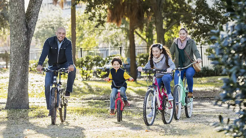 Family of four riding bikes