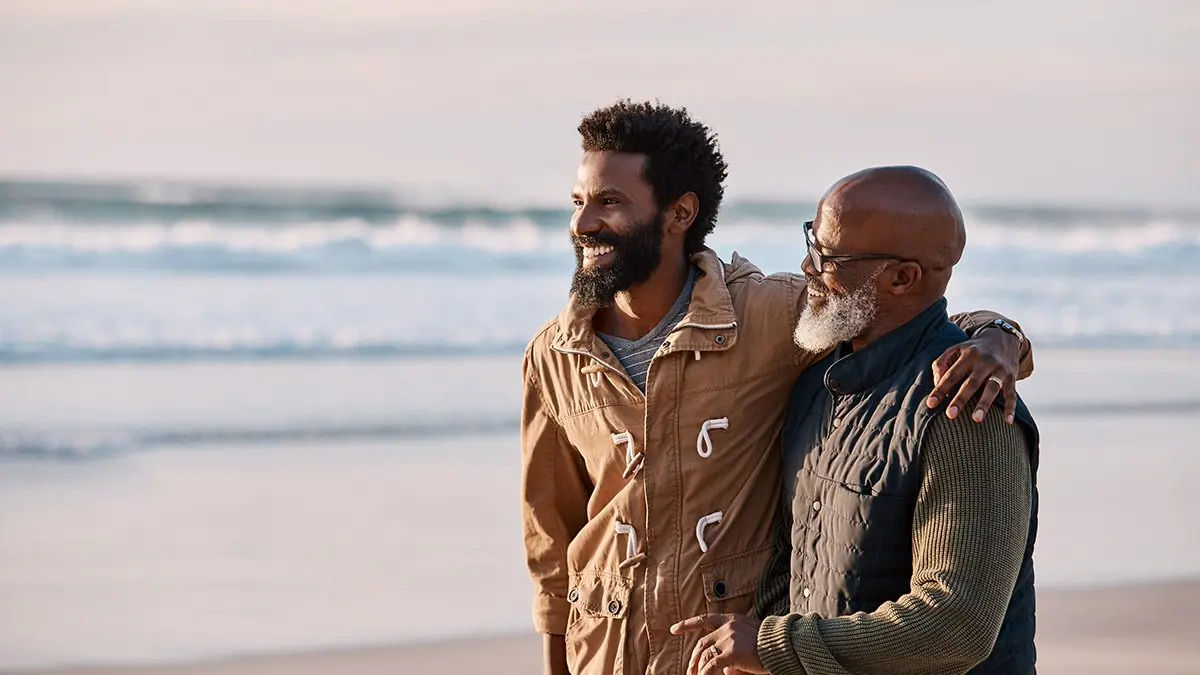 A couple of men standing on a beach