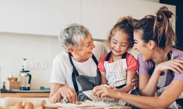 grandma, mom and grandaughter in kitchen baking