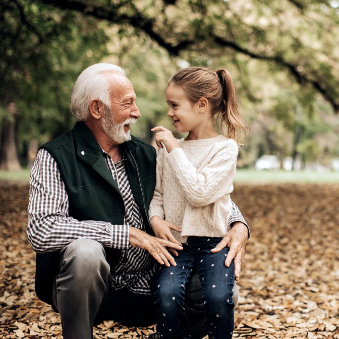 Grandfather with granddaughter in the woods