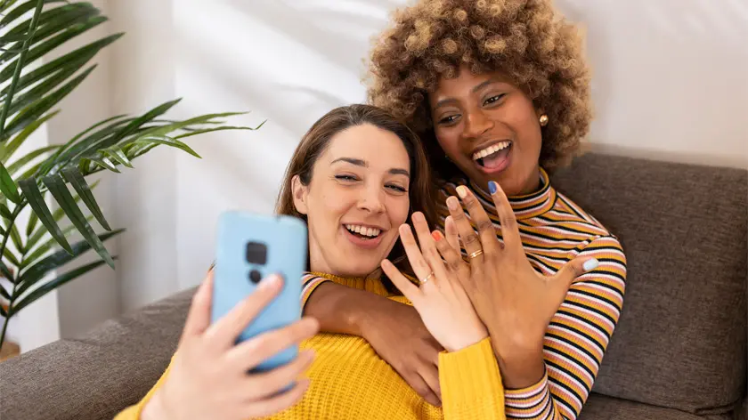 Newlyweds taking selfie of wedding rings