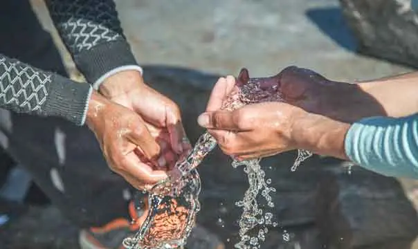 close up of hands in water