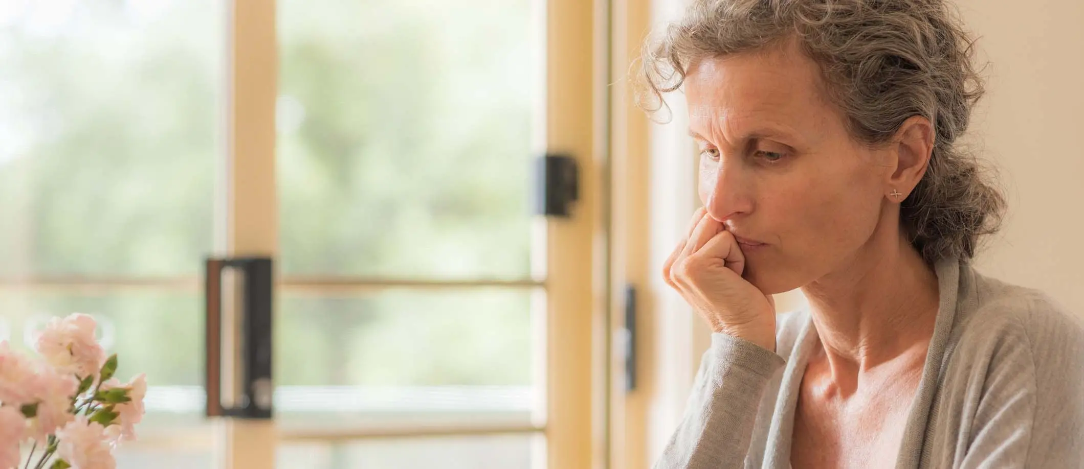 woman sitting in home reflecting on life