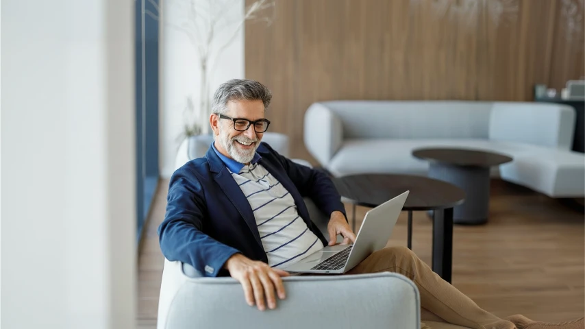 Man sitting on sofa with laptop