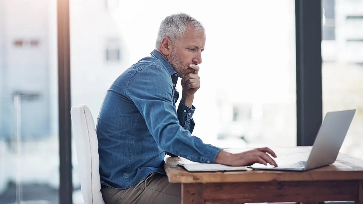 mature man working at computer
