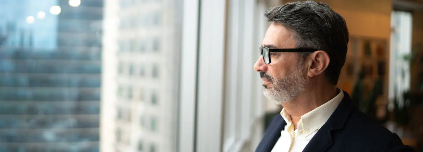 mature man looking out the window