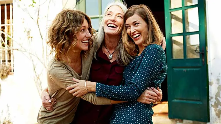 Mother hugging daughters