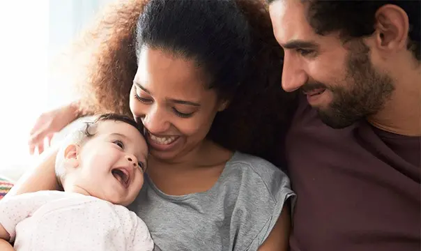 Young couple holding baby