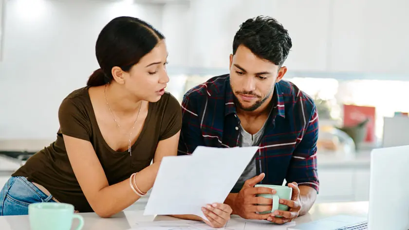 young couple reviewing tax diversification in their kitchen
