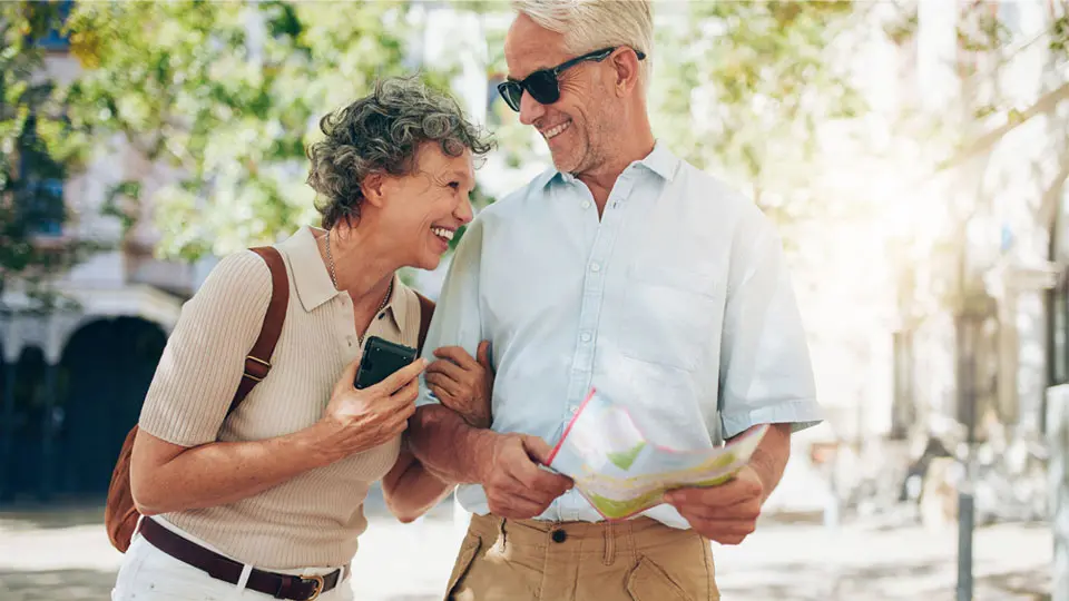 retired couple laughing and exploring a new city