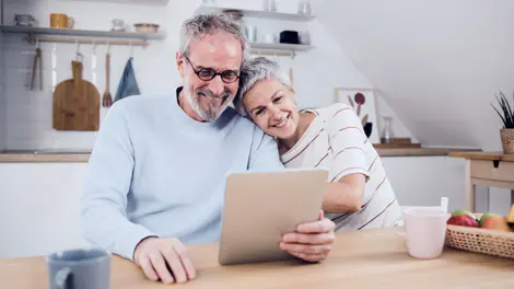 Couple calculating retirement income on a tablet