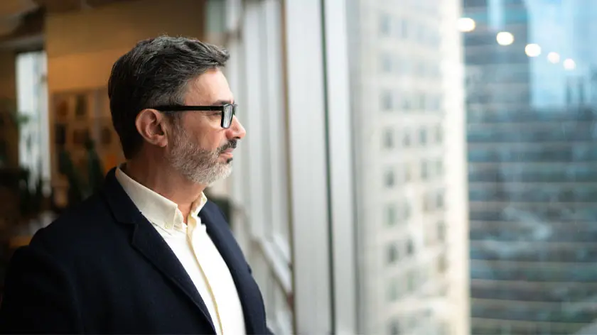 Man looking out window