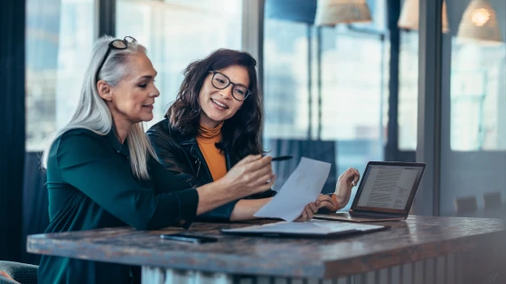 Two business professionals reviewing documents together