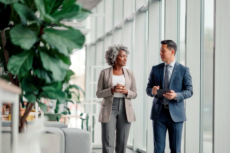 Two professionals walking and discussing wealth planning