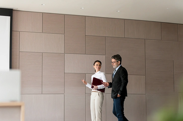 two leadership prfessionals walking in meeting room