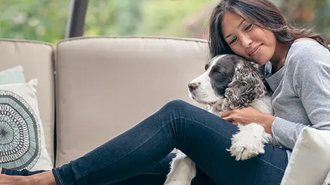 Woman with her dog on a couch
