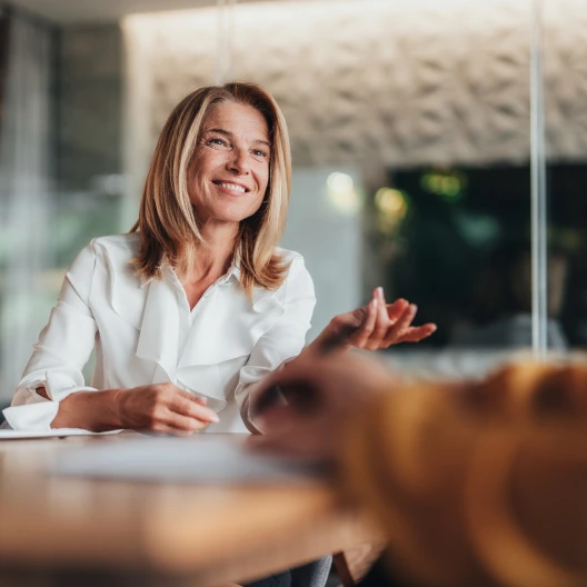 Business executive sitting in board room discussing risk