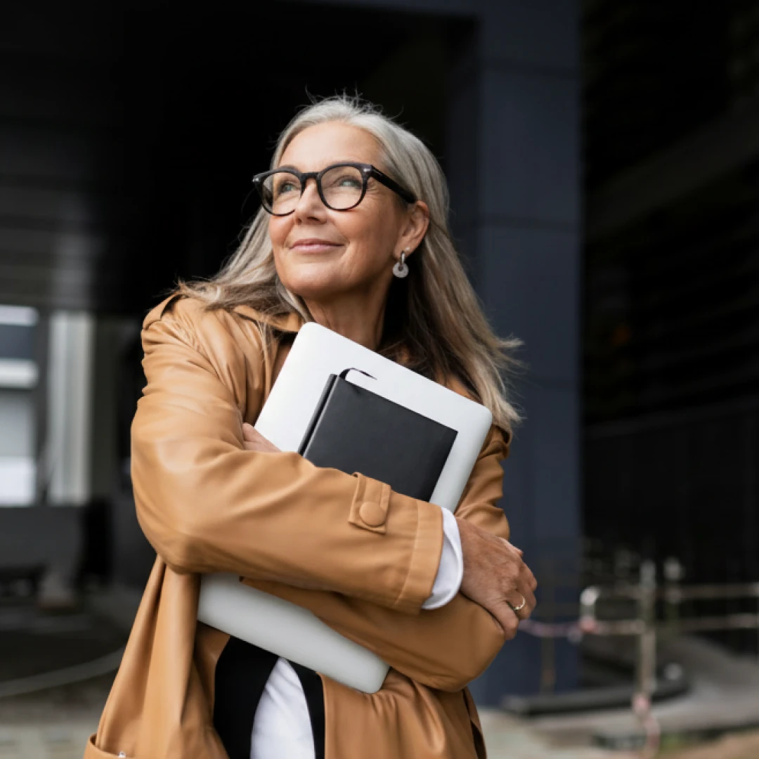 Female business executive holding a notebook and a tablet