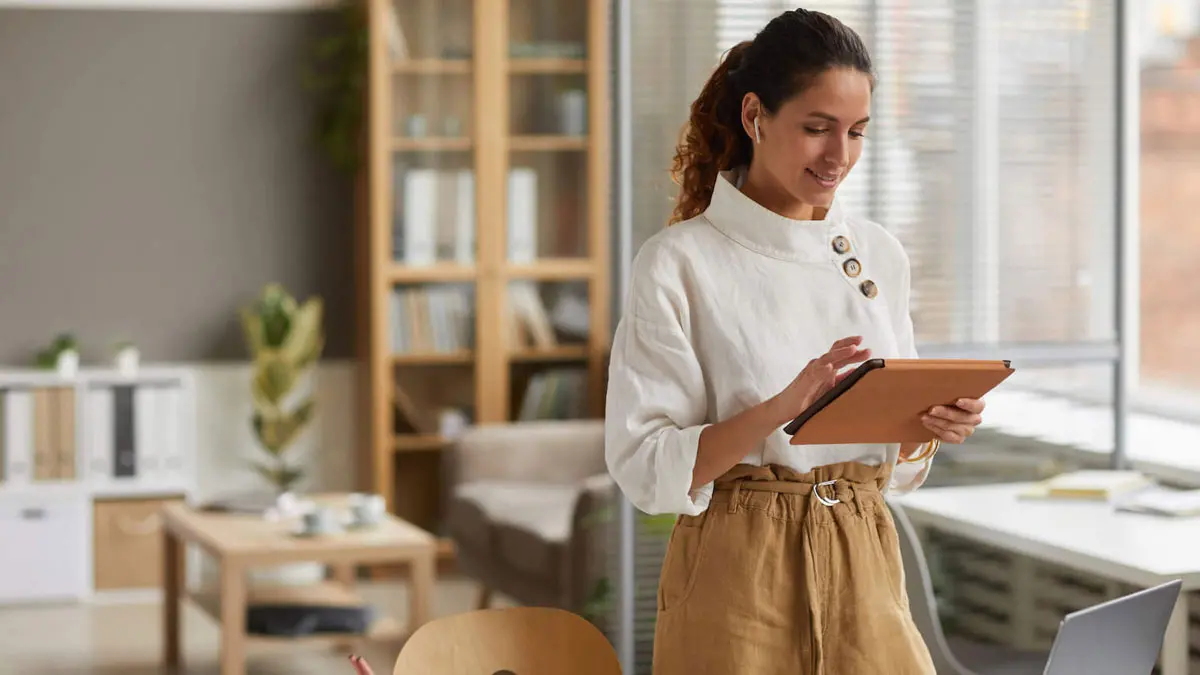 woman working in office looking at tablet