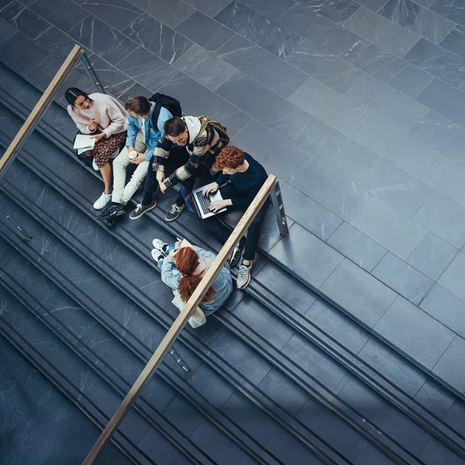 Group of students sitting on stairs