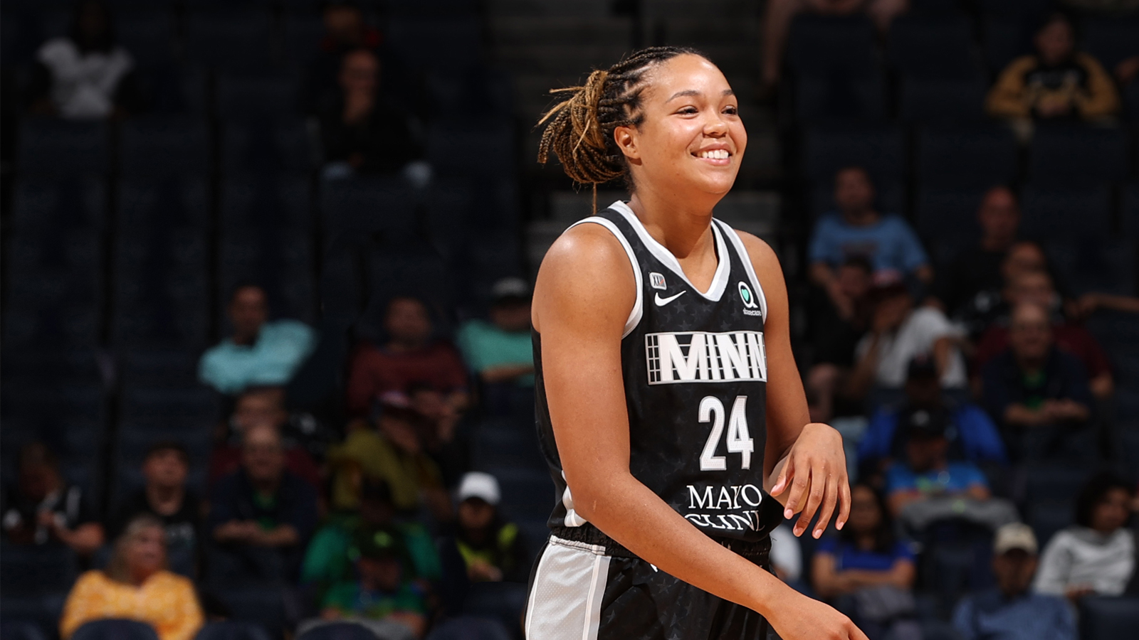 WNBA player smiling on the court