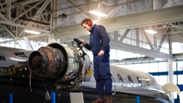 Airplane mechanic working on airplane